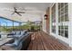 Brick patio with covered seating area and lake view at 1324 Mirror Nw Ter, Winter Haven, FL 33881
