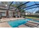 Large screened-in pool with spa and lounge chairs at 1324 Mirror Nw Ter, Winter Haven, FL 33881