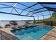 Resort-style pool and spa with lake view and screened enclosure at 1324 Mirror Nw Ter, Winter Haven, FL 33881