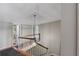 Upstairs hallway with wood railing and chandelier at 1324 Mirror Nw Ter, Winter Haven, FL 33881