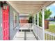 Covered porch with white railings and a bench at 149 Avenue E Sw, Winter Haven, FL 33880