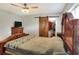 Comfortable bedroom with a large bed, a ceiling fan, and a barn door closet at 149 Avenue E Sw, Winter Haven, FL 33880