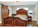 Main bedroom with a wooden bed frame and a sliding barn door to the closet at 149 Avenue E Sw, Winter Haven, FL 33880