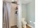 Clean bathroom with a shower, toilet and a grey shower curtain at 149 Avenue E Sw, Winter Haven, FL 33880