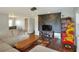 Bright living room with sectional sofa, coffee table, and an arcade game at 149 Avenue E Sw, Winter Haven, FL 33880