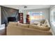 Spacious living room featuring a large sectional sofa, a projector, and an arcade game at 149 Avenue E Sw, Winter Haven, FL 33880