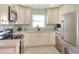 Updated kitchen with white cabinets, stainless steel appliances, and granite countertops at 149 Avenue E Sw, Winter Haven, FL 33880