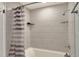 Clean bathroom with a shower/tub combo and striped curtain at 149 Avenue E Sw, Winter Haven, FL 33880