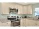 Well-equipped kitchen with ample cabinetry and stainless steel appliances at 149 Avenue E Sw, Winter Haven, FL 33880