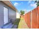 Small backyard with wooden fence and side access at 149 Avenue E Sw, Winter Haven, FL 33880