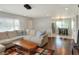 Open concept living room and dining area with hardwood floors and large sectional sofa at 149 Avenue E Sw, Winter Haven, FL 33880