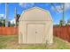 Tan colored storage shed in backyard at 149 Avenue E Sw, Winter Haven, FL 33880