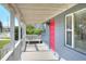 Front porch with white railings and red door at 149 Avenue E Sw, Winter Haven, FL 33880