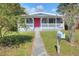 Gray house with red door and covered porch at 149 Avenue E Sw, Winter Haven, FL 33880