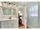 Bright bathroom features a white vanity, updated fixtures, and a shower at 149 Avenue E Sw, Winter Haven, FL 33880
