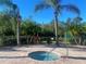Community hot tub surrounded by palm trees and lush landscaping at 1561 Vienna Square Dr, Winter Haven, FL 33884
