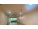 Open living room with tile floors and access to a screened-in patio at 1561 Vienna Square Dr, Winter Haven, FL 33884