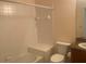 Bathroom with tub, toilet, and tile walls at 1561 Vienna Square Dr, Winter Haven, FL 33884