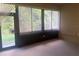 Bright sunroom with multiple windows and view of lush greenery at 1561 Vienna Square Dr, Winter Haven, FL 33884