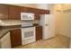 Kitchen with white appliances and wood cabinets at 1561 Vienna Square Dr, Winter Haven, FL 33884