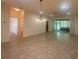 Dining room with tile flooring and a view of the living room and patio at 1561 Vienna Square Dr, Winter Haven, FL 33884