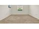 Bright bedroom with neutral carpeting and large window at 1613 Linz Ct, Winter Haven, FL 33884