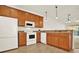 Well-equipped kitchen with wood cabinets and granite countertops at 1613 Linz Ct, Winter Haven, FL 33884