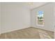 Well-lit bedroom featuring neutral carpeting and arched window at 1613 Linz Ct, Winter Haven, FL 33884