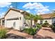 Tan house with a two-car garage and brick pavers at 1613 Linz Ct, Winter Haven, FL 33884