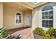 Front entrance with arched windows and brick walkway at 1613 Linz Ct, Winter Haven, FL 33884