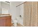 Bathroom with tub and shower, wood vanity, and patterned curtain at 1613 Linz Ct, Winter Haven, FL 33884