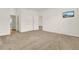 Spacious bedroom with neutral carpeting and en-suite bathroom at 1613 Linz Ct, Winter Haven, FL 33884