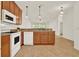 Kitchen with wood cabinets, granite countertops and stainless steel appliances at 1613 Linz Ct, Winter Haven, FL 33884