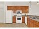 Kitchen with white appliances and wood cabinets at 1613 Linz Ct, Winter Haven, FL 33884