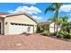 Two-car garage with brick paver driveway at 1613 Linz Ct, Winter Haven, FL 33884