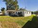 Large backyard with grassy area and covered patio at 213 Rhea Cir, Lakeland, FL 33813