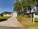 Newly built home with a white exterior, attached garage, and landscaped lawn at 213 Rhea Cir, Lakeland, FL 33813