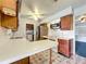 Kitchen boasts wood cabinets, white countertops, and appliances at 221 Dorothy St, Auburndale, FL 33823