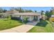 Cute one-story home with a covered porch and well-maintained lawn at 221 Dorothy St, Auburndale, FL 33823