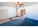 Spacious living room with blue carpet and built-in storage at 221 Dorothy St, Auburndale, FL 33823