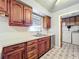 Kitchen features wood cabinets, a double sink, and access to laundry at 221 Dorothy St, Auburndale, FL 33823