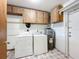 Laundry room with washer, dryer, and ample storage at 221 Dorothy St, Auburndale, FL 33823