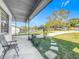 Relaxing covered patio with a view of the backyard at 221 Dorothy St, Auburndale, FL 33823