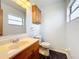 Clean bathroom with wood vanity and updated fixtures at 221 Dorothy St, Auburndale, FL 33823