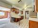 Kitchen with wooden cabinets, white countertops, and tiled floor at 221 Dorothy St, Auburndale, FL 33823