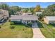 Single story home with a large yard and driveway at 221 Dorothy St, Auburndale, FL 33823