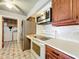 Bright kitchen with stainless steel appliances and wood cabinets at 221 Dorothy St, Auburndale, FL 33823
