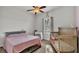 Bedroom with crib, queen bed and ceiling fan at 2821 Sheldon St, Lakeland, FL 33813