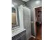 Bathroom with double vanity, large mirror, and linen storage at 312 Douglas Park Ave, Davenport, FL 33897