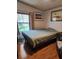 Spacious bedroom with a queen-size bed and wood floors at 312 Douglas Park Ave, Davenport, FL 33897